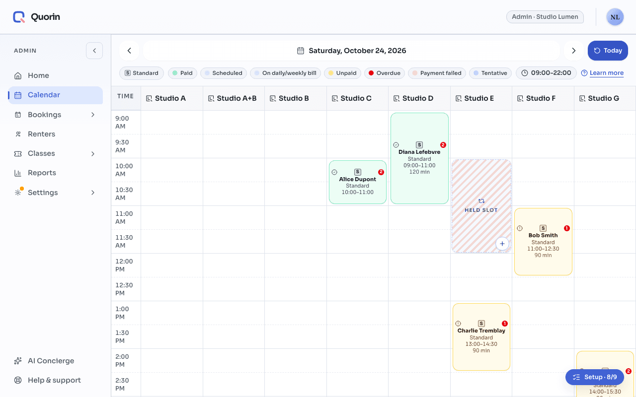 One day on the admin calendar: in the Studio E column, a striped block labelled “Held slot”, from 10 a.m. to noon, next to ordinary bookings.